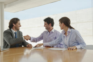 A sales rep shaking hands with new customers